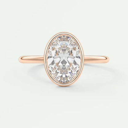 18-karat rose gold oval diamond engagement ring with a bezel setting.