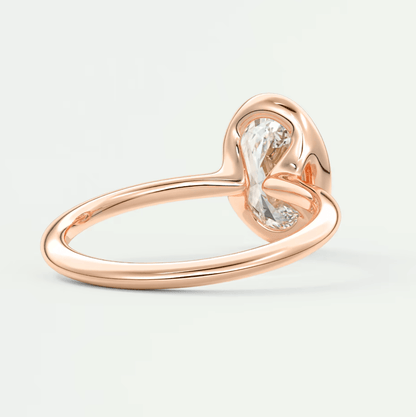 Rose gold heart-shaped diamond engagement ring with a single large stone.