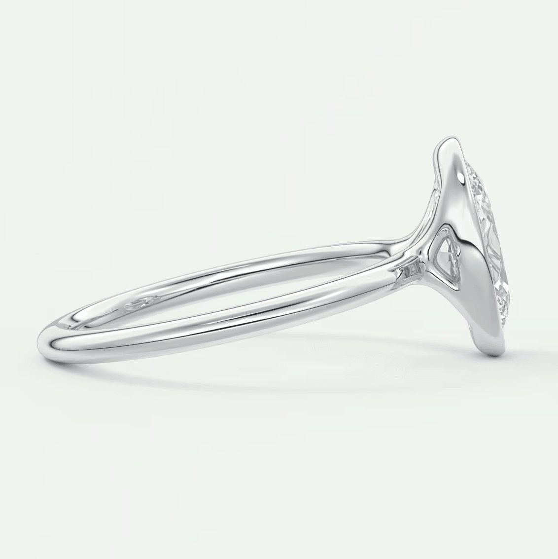 White gold diamond engagement ring with a marquise-cut center stone and halo detailing.
