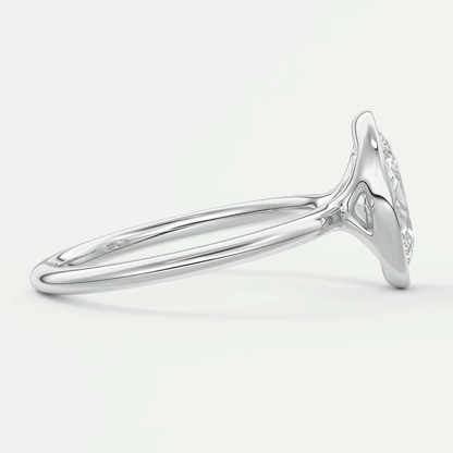 White gold diamond engagement ring with a marquise-cut center stone and halo detailing.