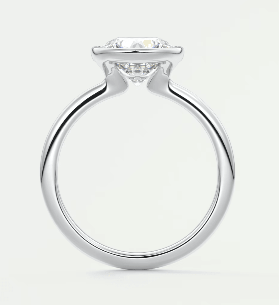 18k white gold solitaire diamond engagement ring with a cushion-cut center stone.