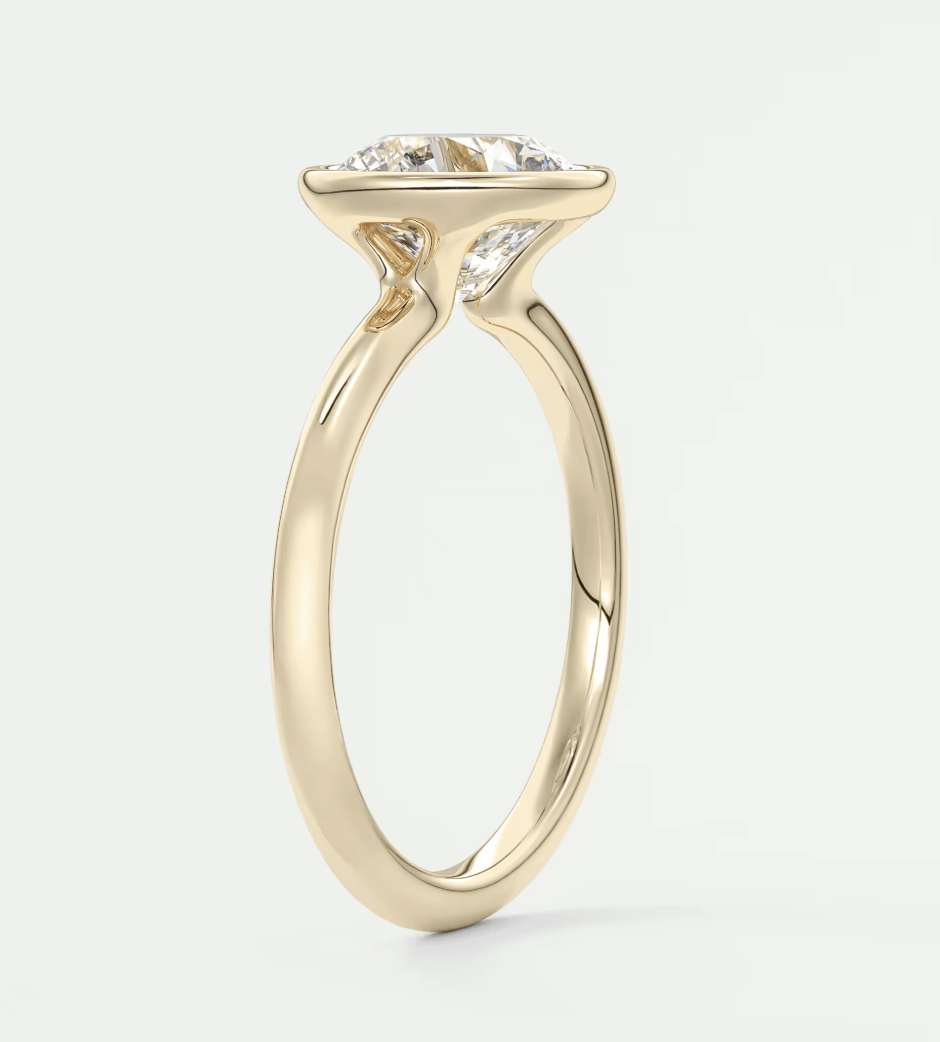 18k yellow gold solitaire engagement ring with a cushion-cut diamond.