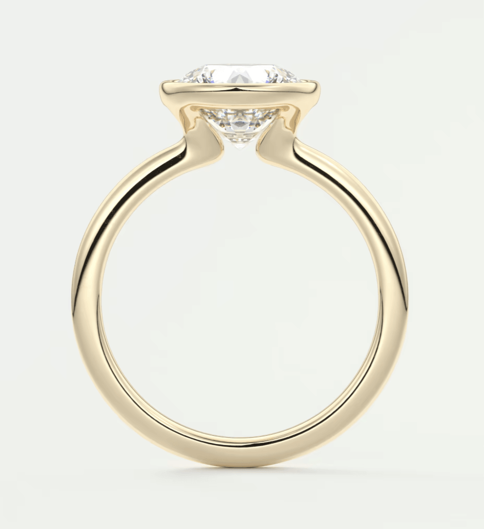 18-karat yellow gold engagement ring with a cushion-cut diamond.