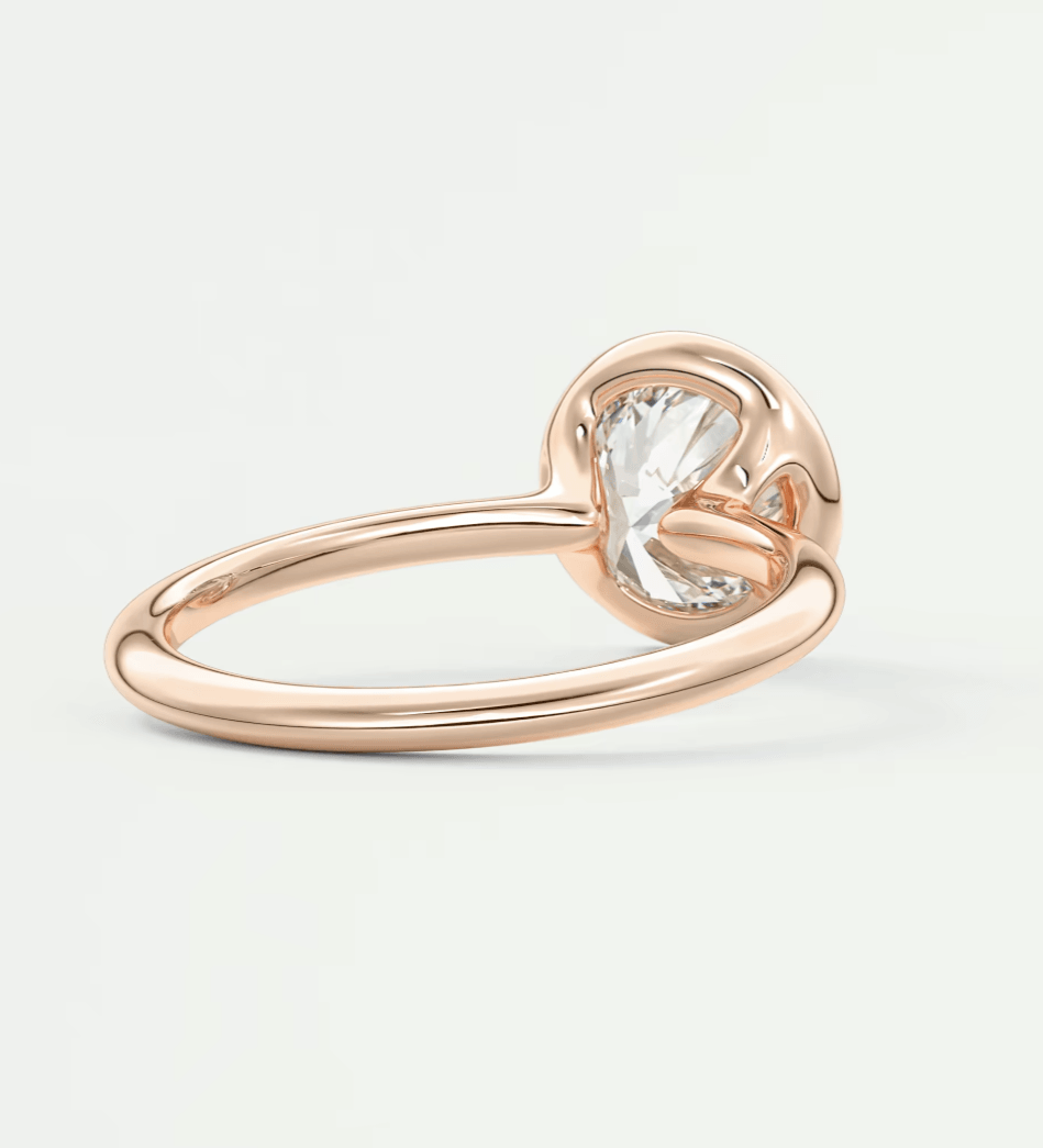 Rose gold engagement ring with a large, central diamond.
