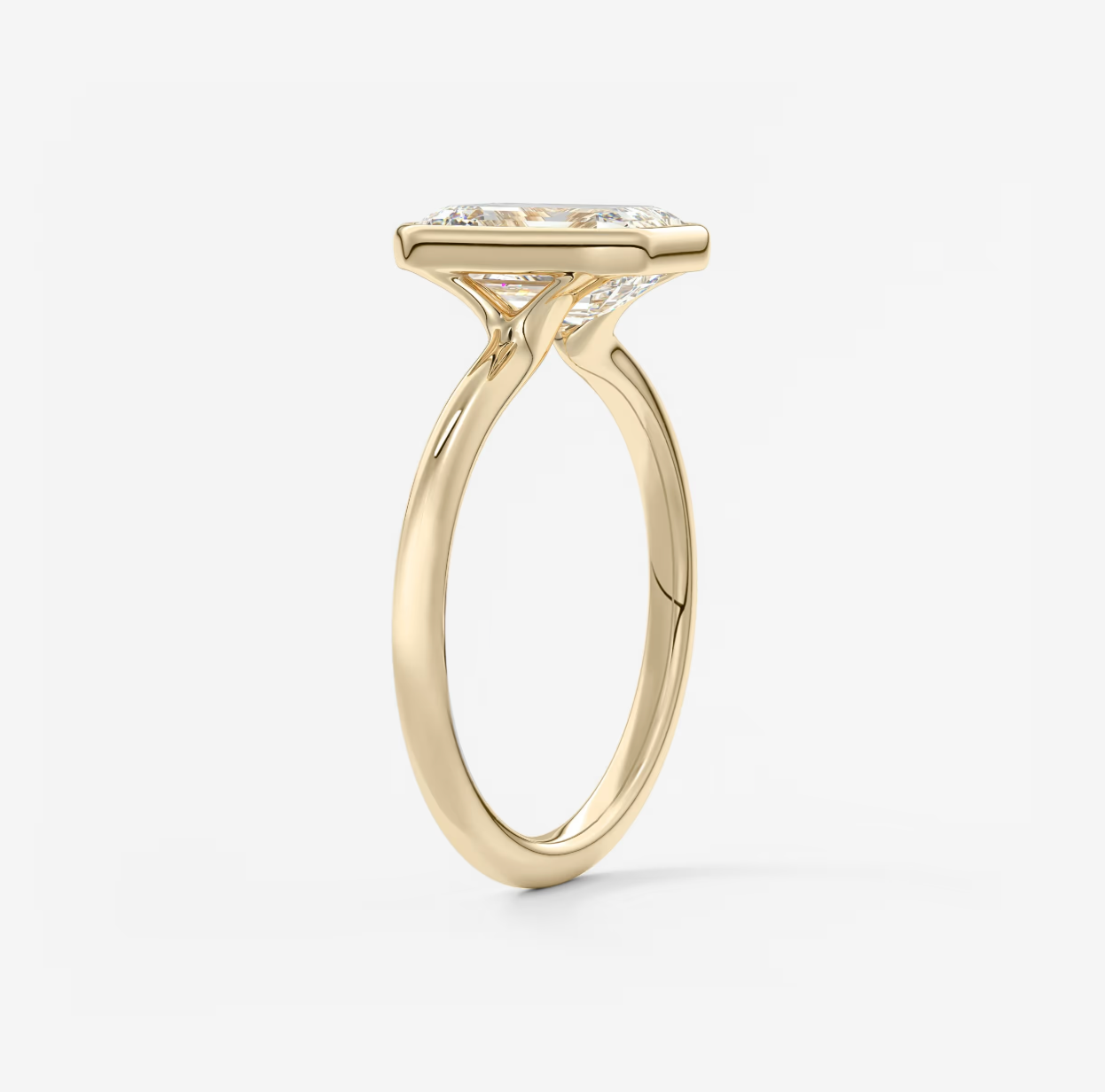 Gold ring with a diamond on a light gray background
