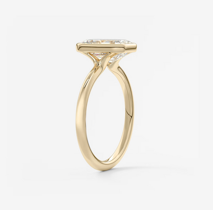 Gold ring with a diamond on a light gray background