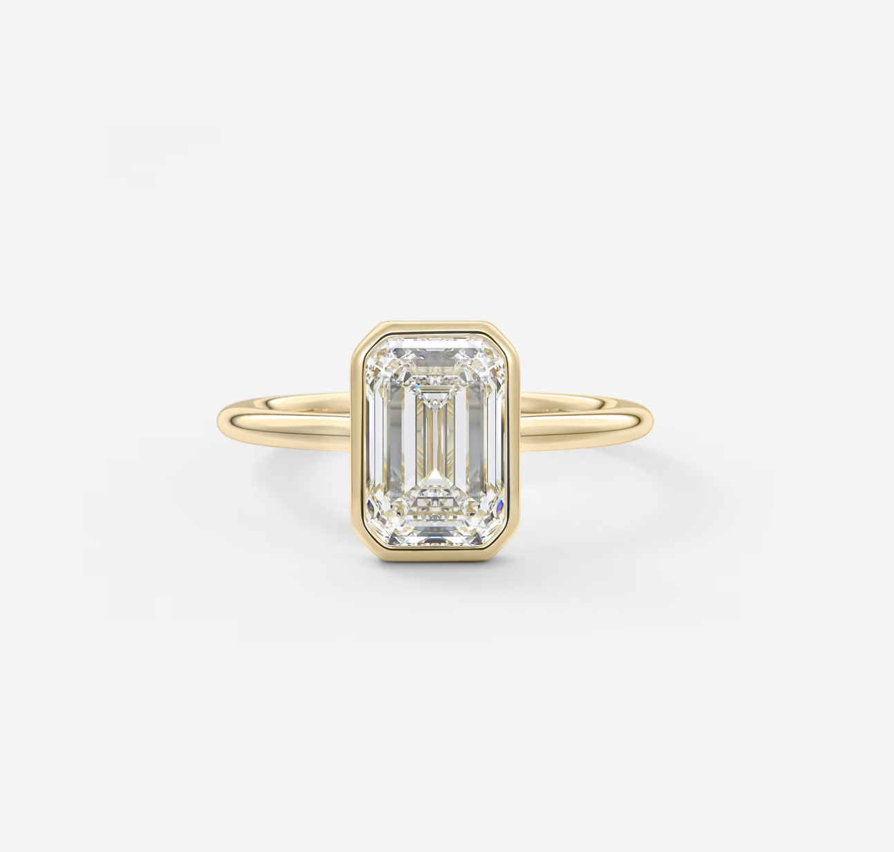 Gold ring with a rectangular diamond on a white background