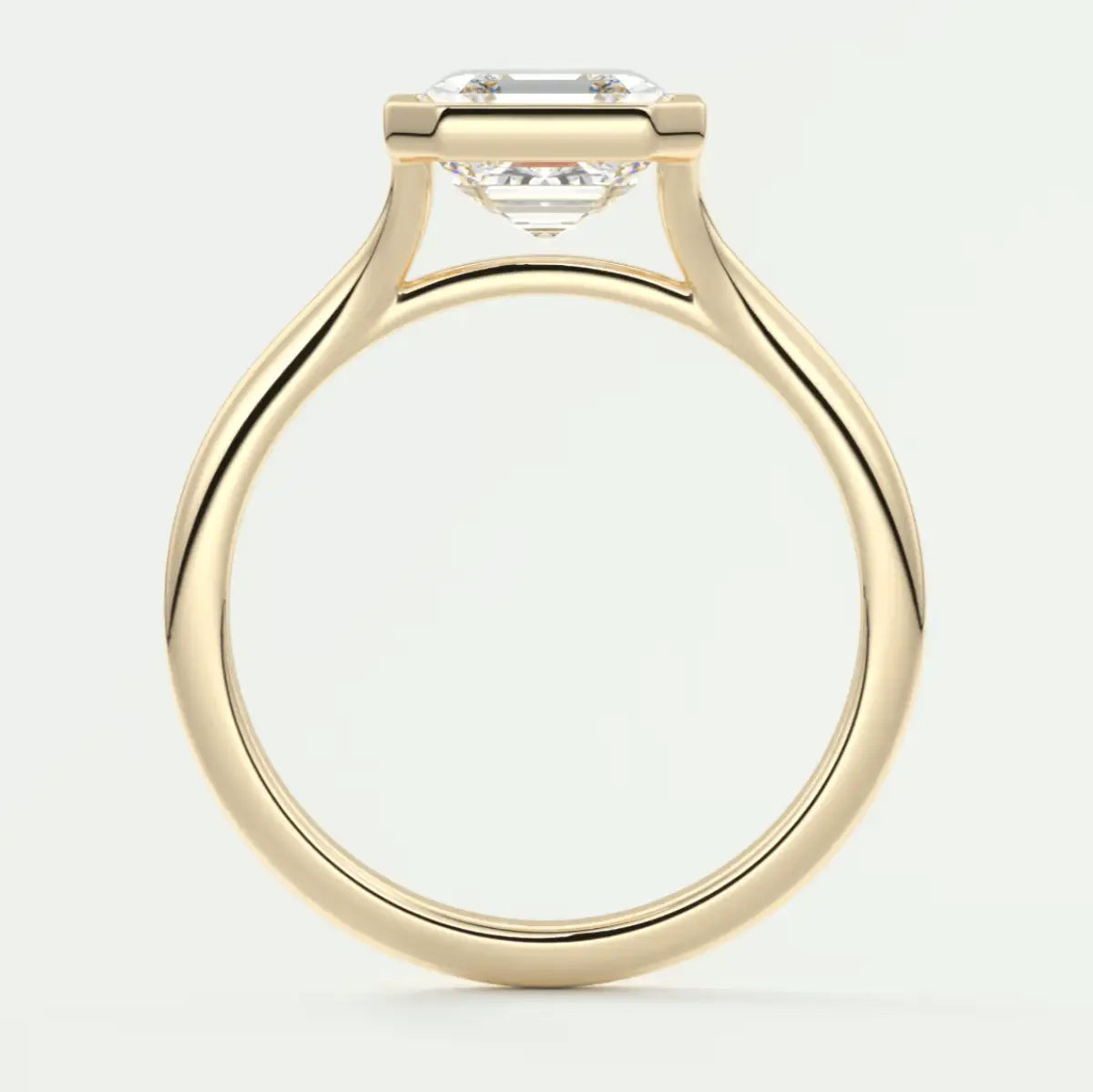 18k yellow gold solitaire engagement ring with a cushion-cut diamond.