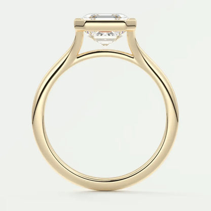 18k yellow gold solitaire engagement ring with a cushion-cut diamond.