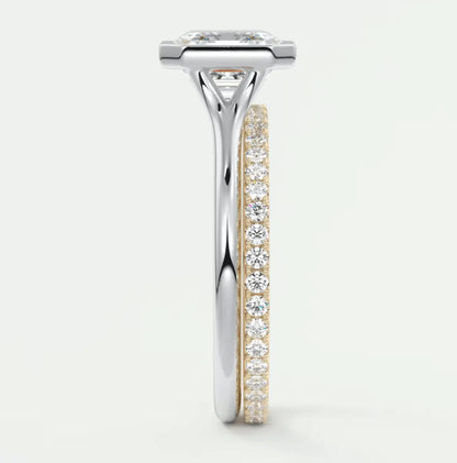 18k white gold diamond engagement ring with a princess cut center stone and pave set diamonds on the band.