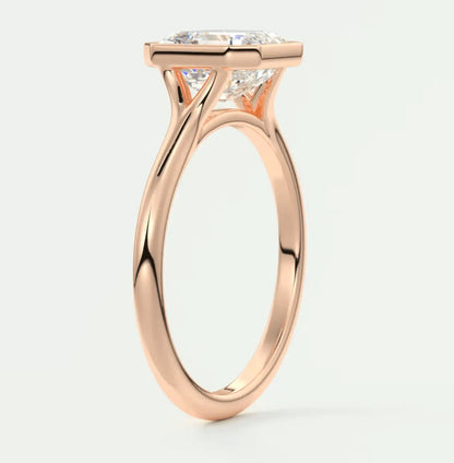 Rose gold diamond engagement ring with a cushion-cut center stone and prong setting.