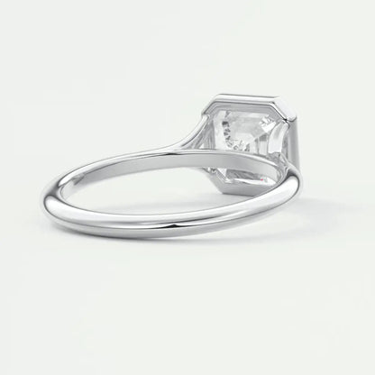 White gold solitaire engagement ring with a princess cut diamond.