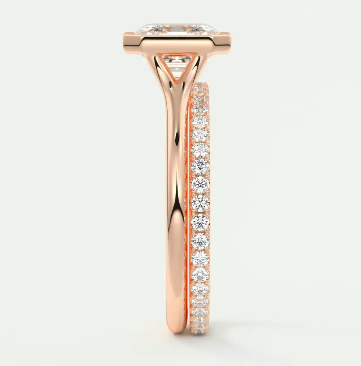 18k rose gold diamond engagement ring with a princess cut center stone and pavé set side stones.