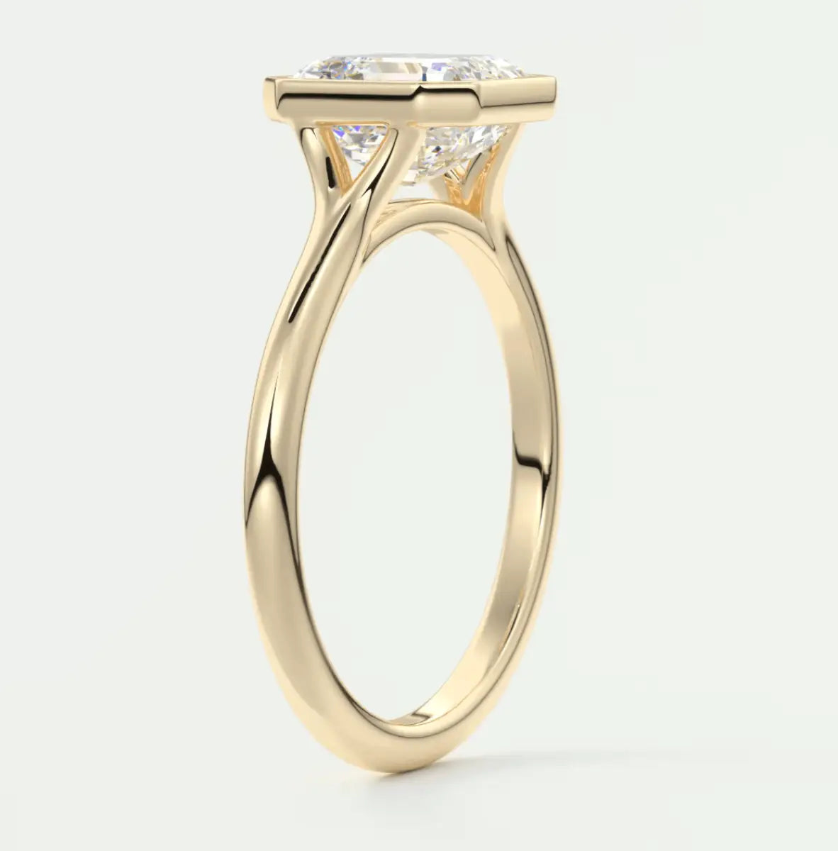 18k yellow gold engagement ring with a cushion-cut diamond.