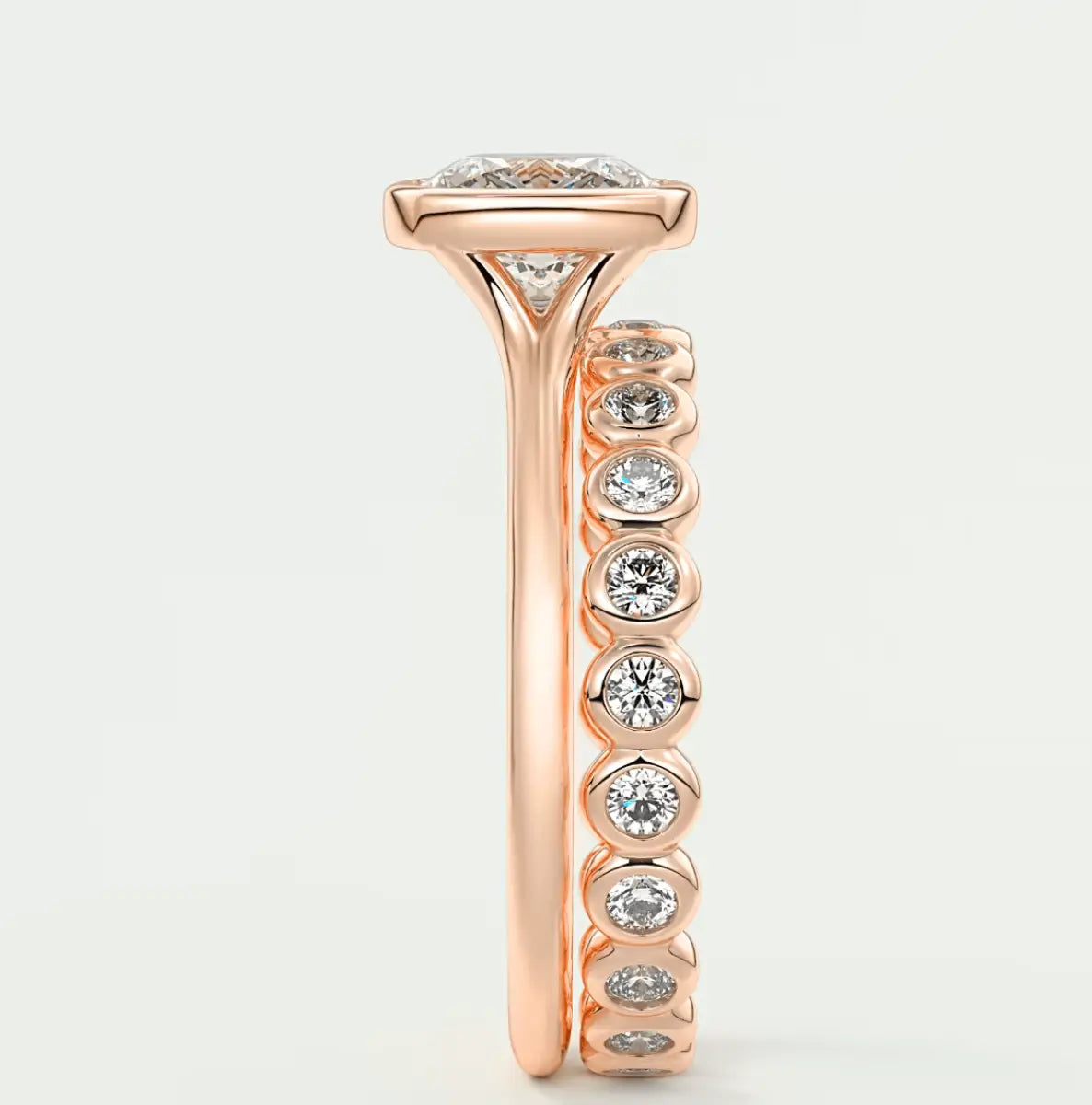 18-karat rose gold diamond engagement ring with a marquise-cut center stone and round side stones.