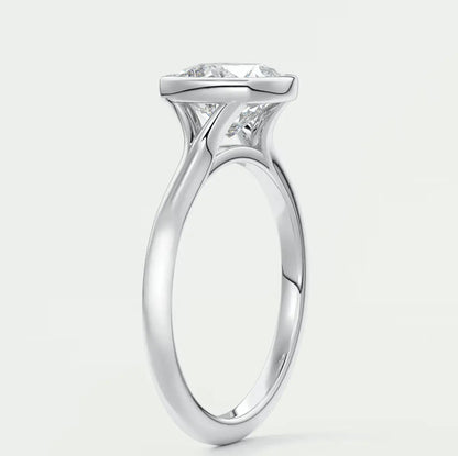 18-karat white gold solitaire engagement ring with a princess-cut diamond.