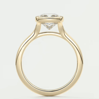 18-karat yellow gold engagement ring with a princess-cut diamond.