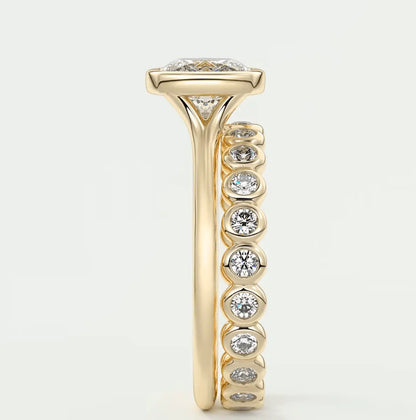 18k yellow gold diamond engagement ring with a marquise-cut center stone and round side stones.