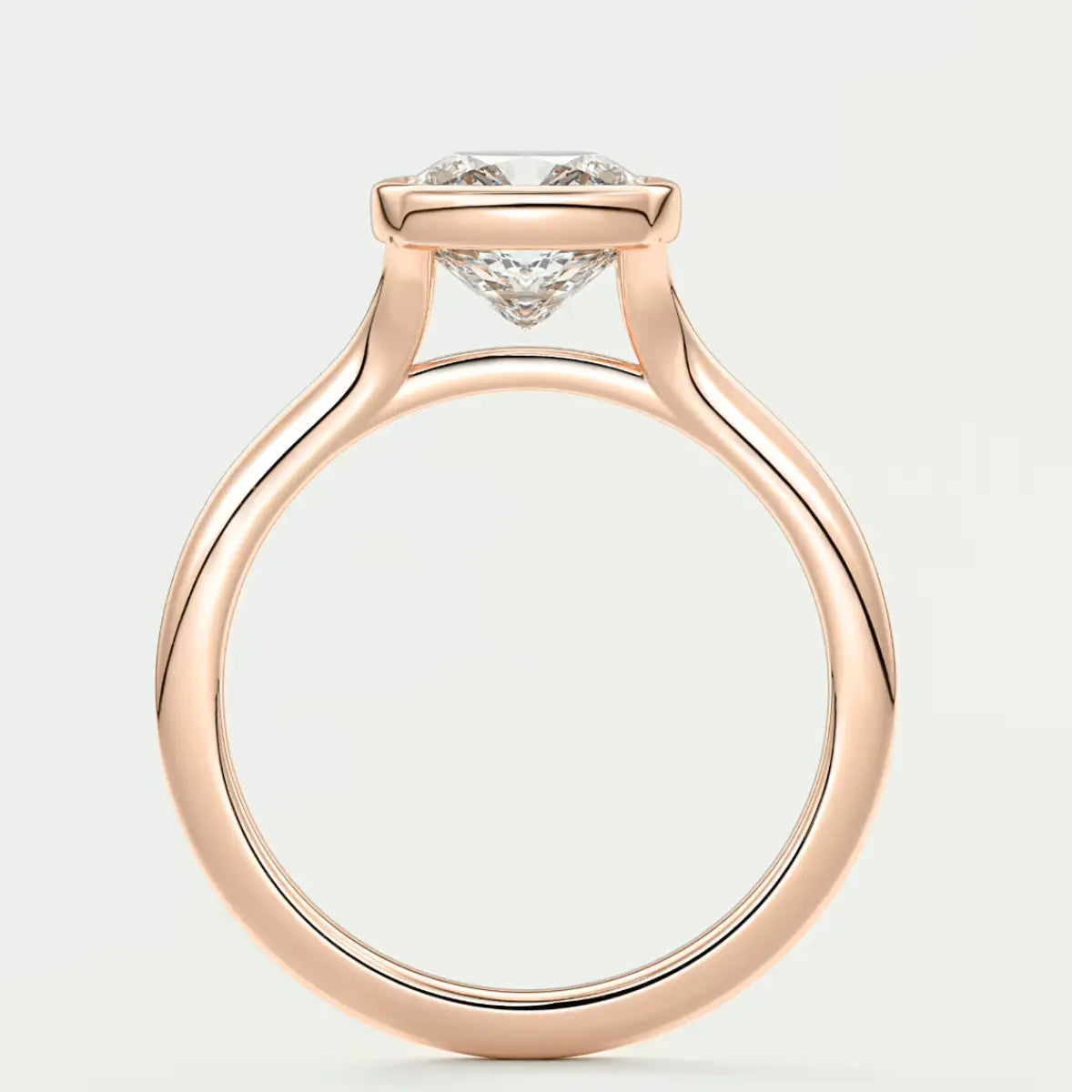 Rose gold diamond engagement ring with a cushion-cut center stone and small side diamonds.