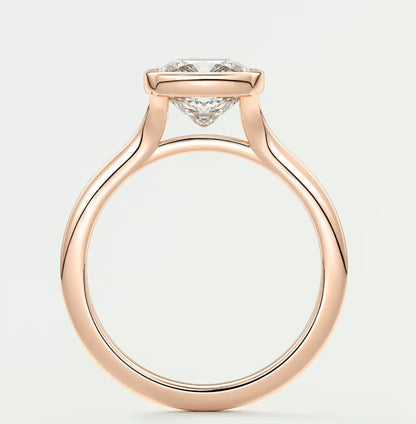 Rose gold diamond engagement ring with a cushion-cut center stone and small side diamonds.