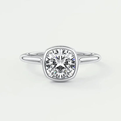 Cushion-cut diamond engagement ring with white gold band, featuring a bezel setting.