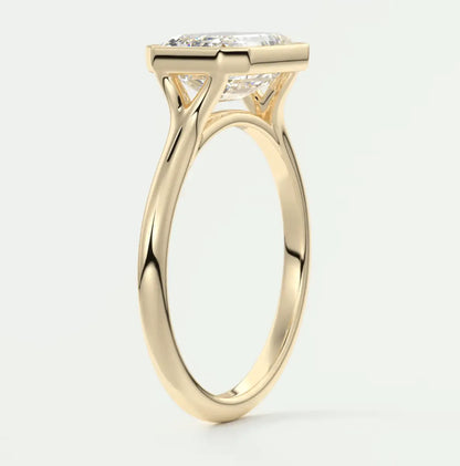 18-karat yellow gold engagement ring with a cushion-cut diamond.