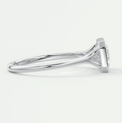 18k white gold diamond engagement ring with a marquise-cut center stone and small diamonds on the band.