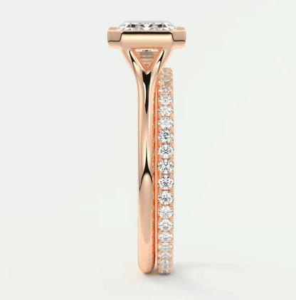18k rose gold diamond engagement ring with a princess cut center stone and pavé set side stones.
