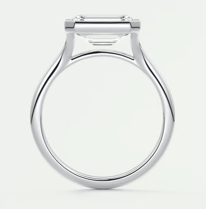 White gold engagement ring with a square-cut diamond.