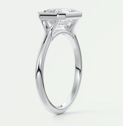 18-karat white gold engagement ring with a princess-cut diamond.