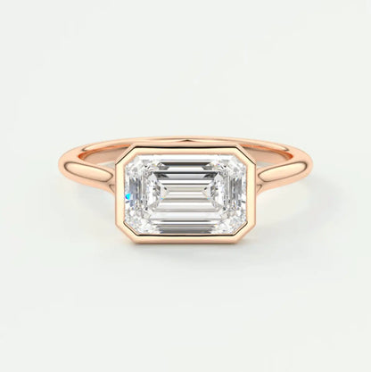 18-karat rose gold emerald-cut diamond engagement ring.
