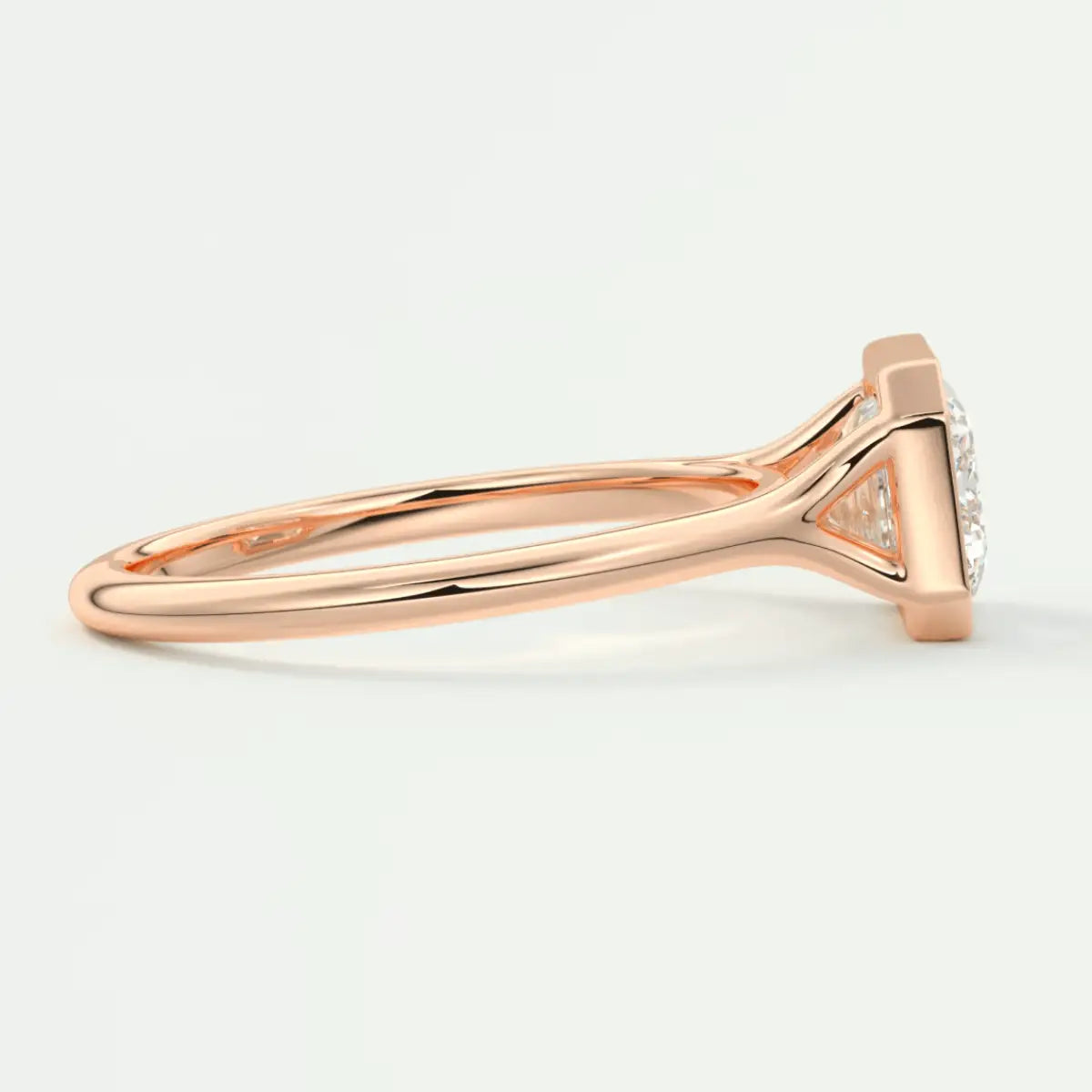 Rose gold diamond engagement ring with a cushion-cut center stone and halo of smaller diamonds.