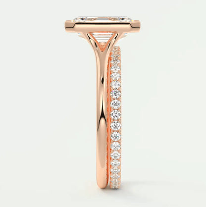 18k rose gold diamond engagement ring with a princess cut center stone and channel set side stones.