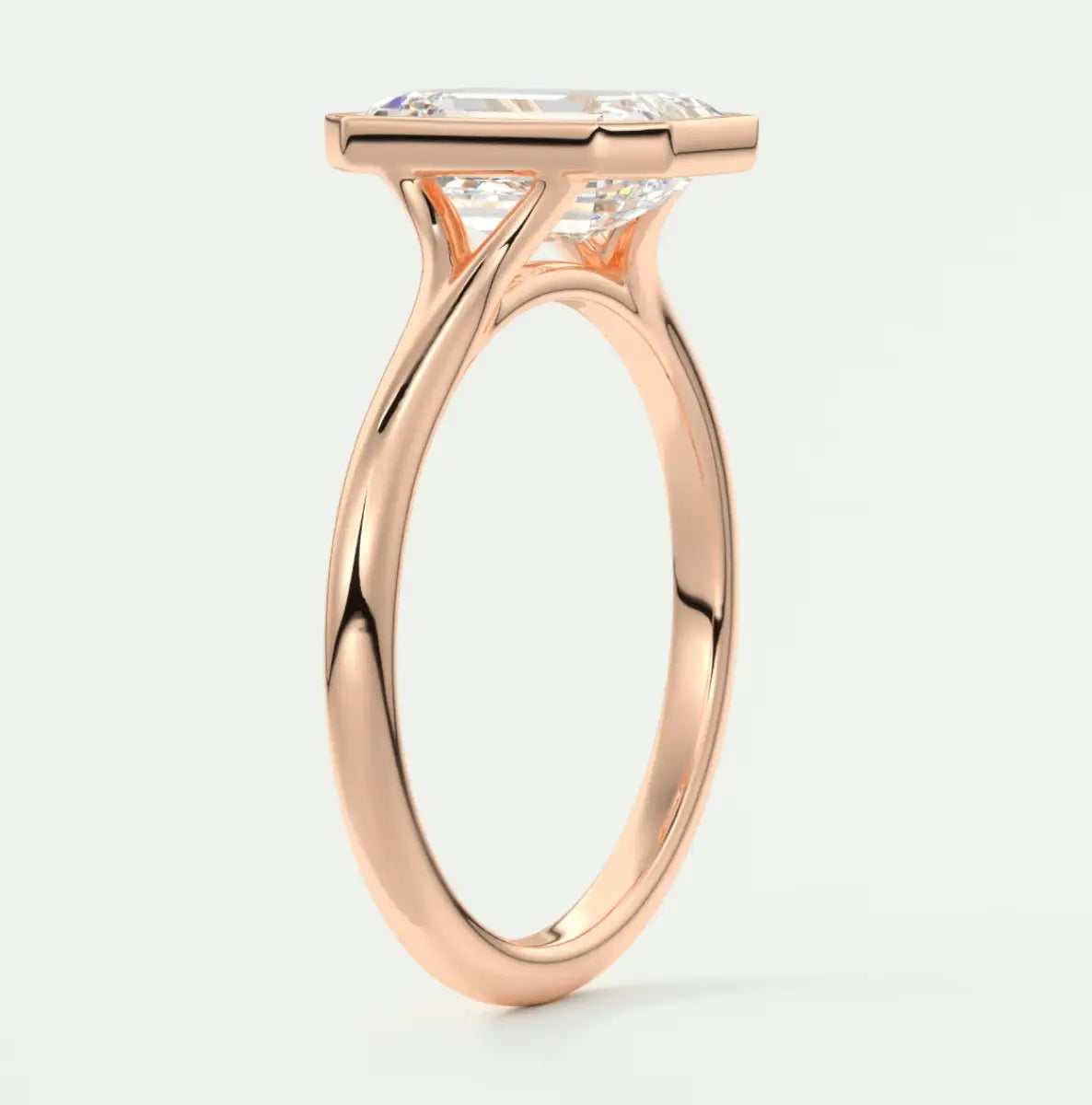Rose gold princess cut diamond engagement ring with a twisted band design.