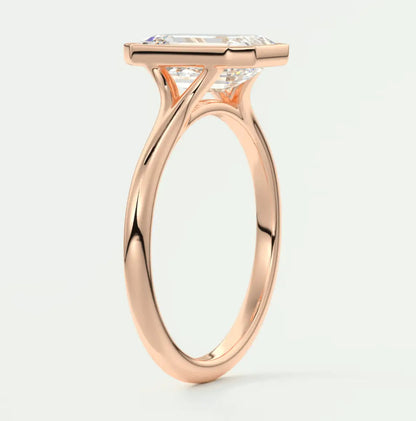 Rose gold princess cut diamond engagement ring with a twisted band design.