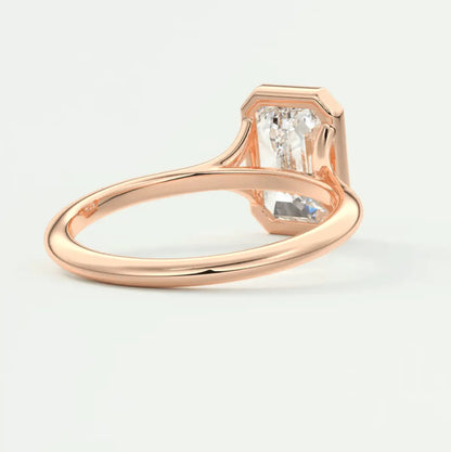Rose gold diamond engagement ring with a hexagonal center stone and smaller side diamonds.