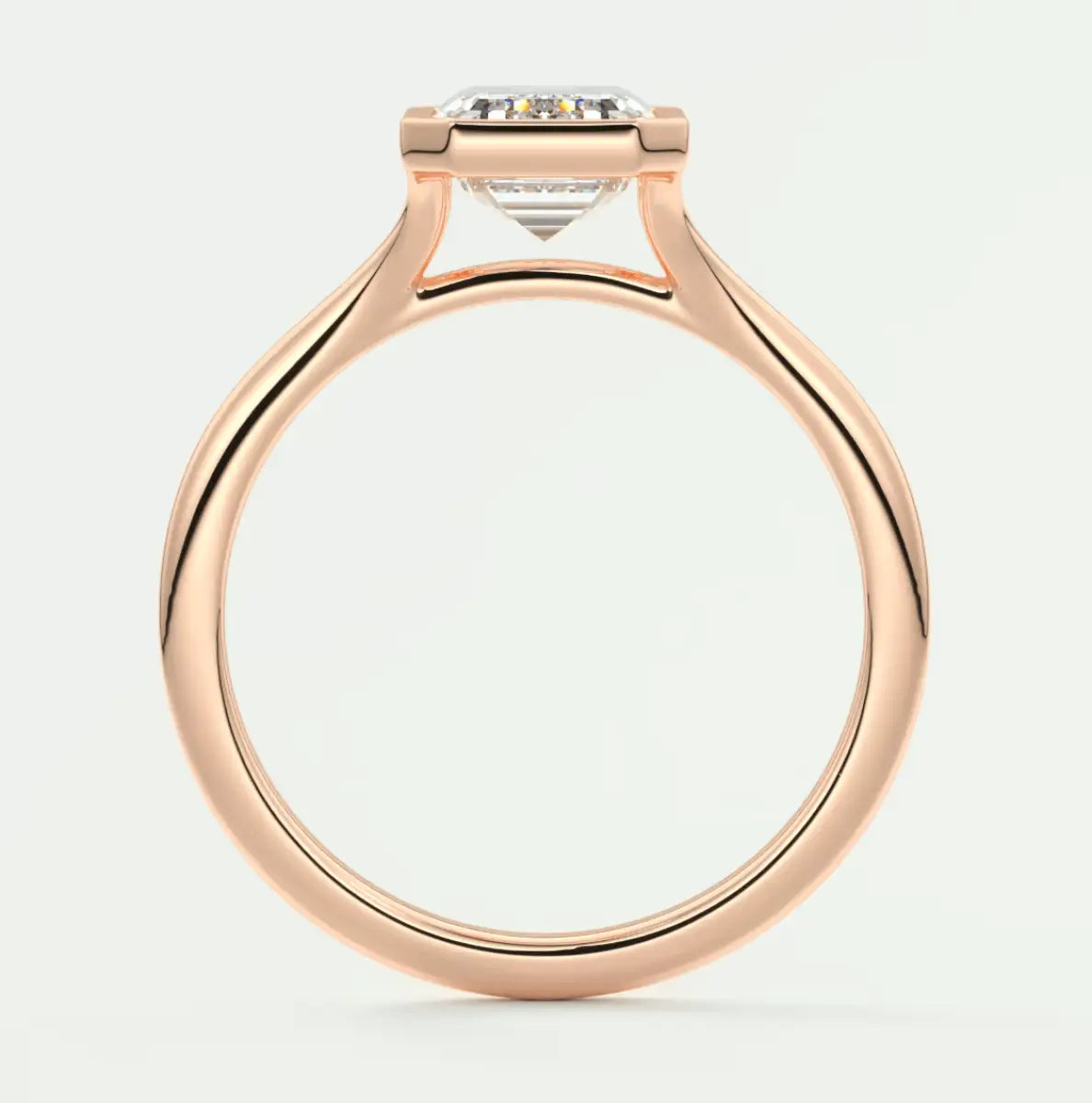 Rose gold engagement ring with a large central diamond and smaller side diamonds, featuring an elegant design.