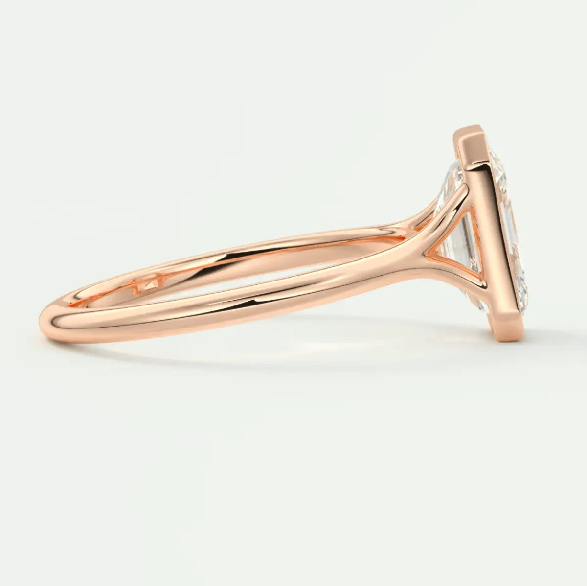 18-karat rose gold engagement ring with a large, round diamond.