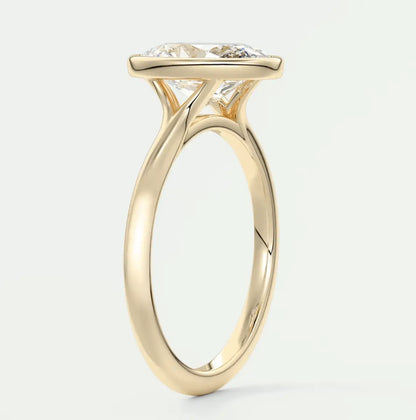 18-karat yellow gold engagement ring with a cushion-cut diamond.
