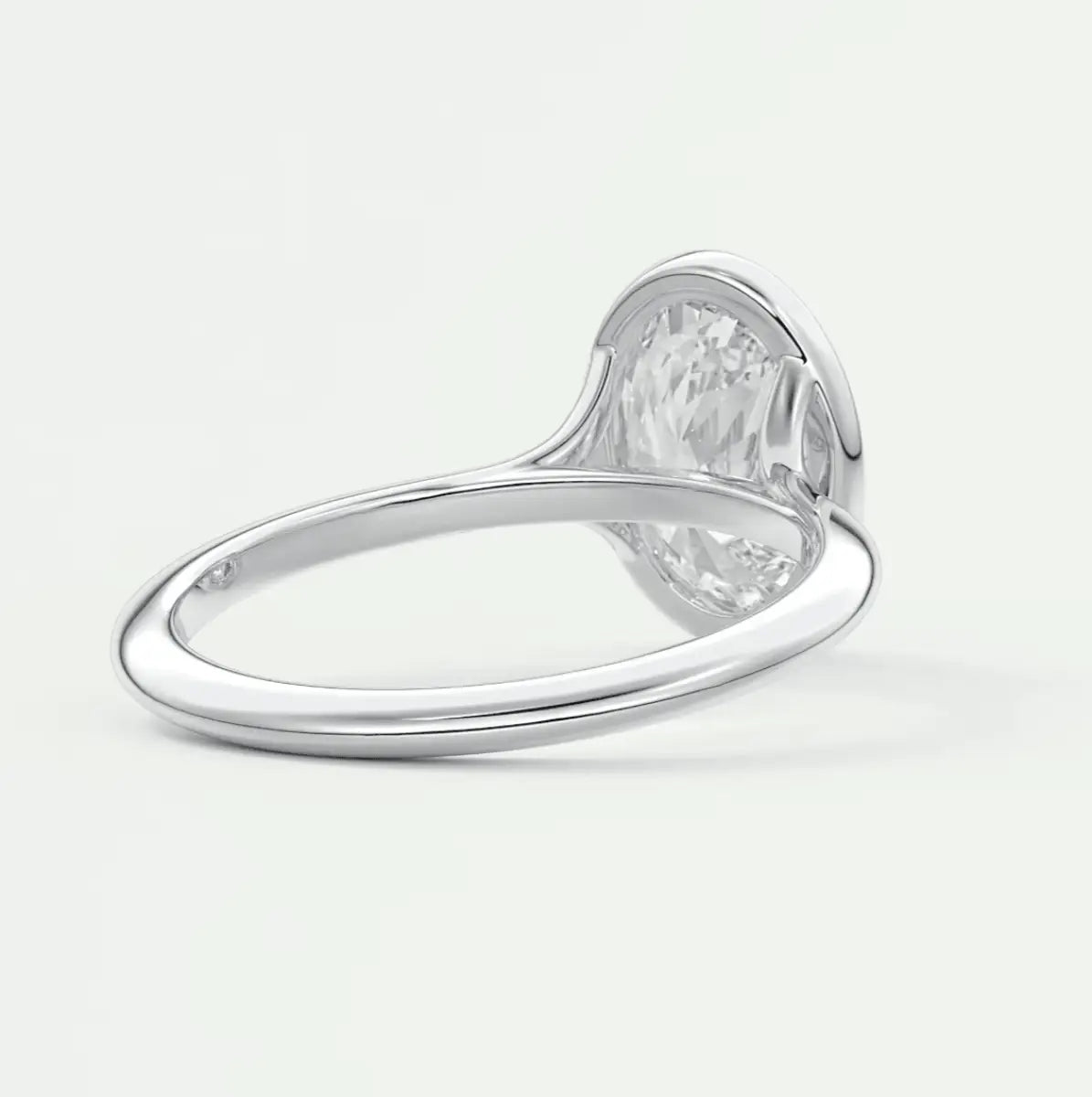 White diamond engagement ring with a heart-shaped band and prong setting.