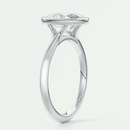 White gold solitaire engagement ring with a cushion-cut diamond.
