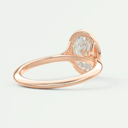 Rose gold engagement ring with a large, cushion-cut diamond.