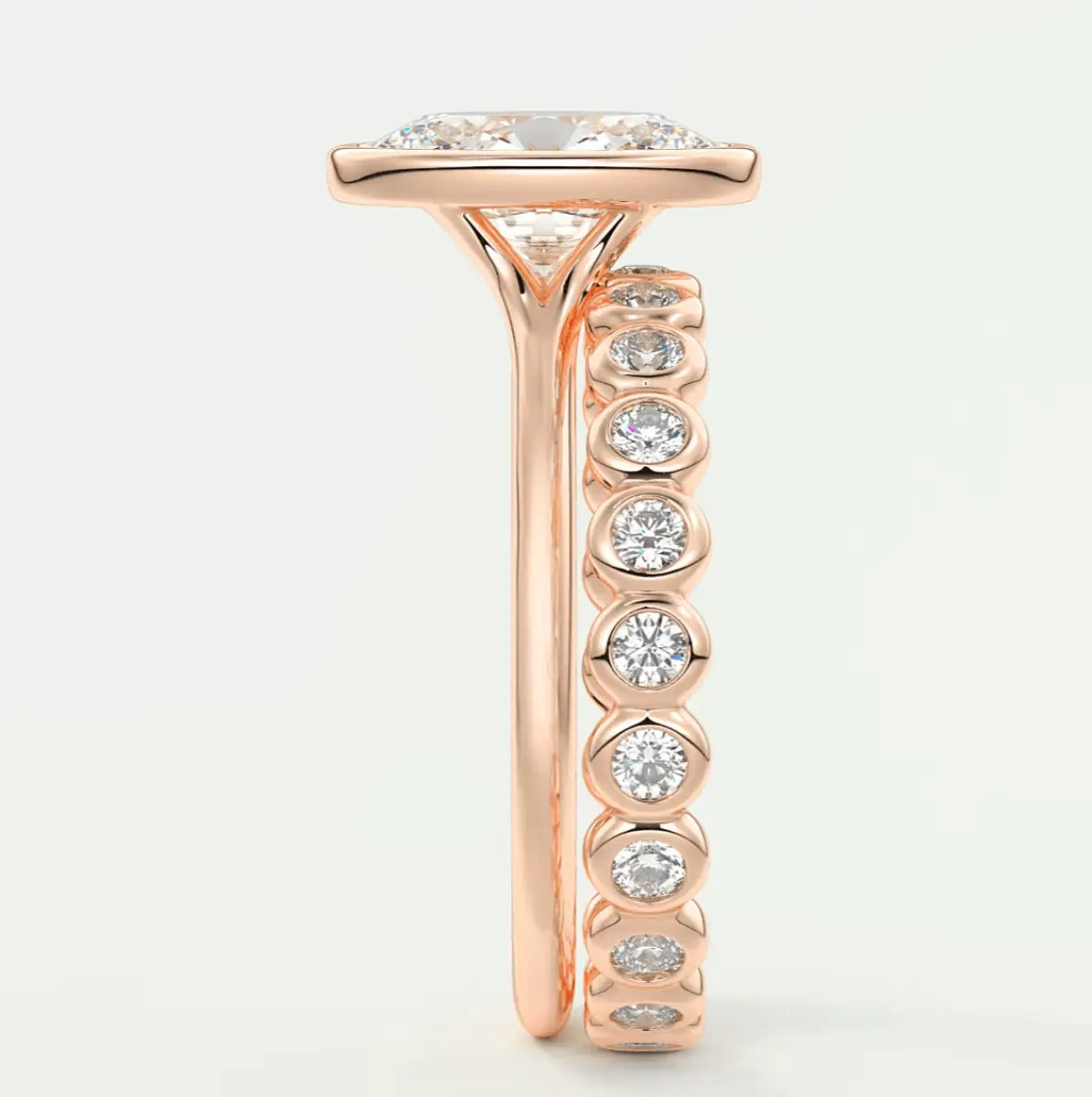18k rose gold diamond engagement ring with a cushion-cut center stone and channel-set side stones.
