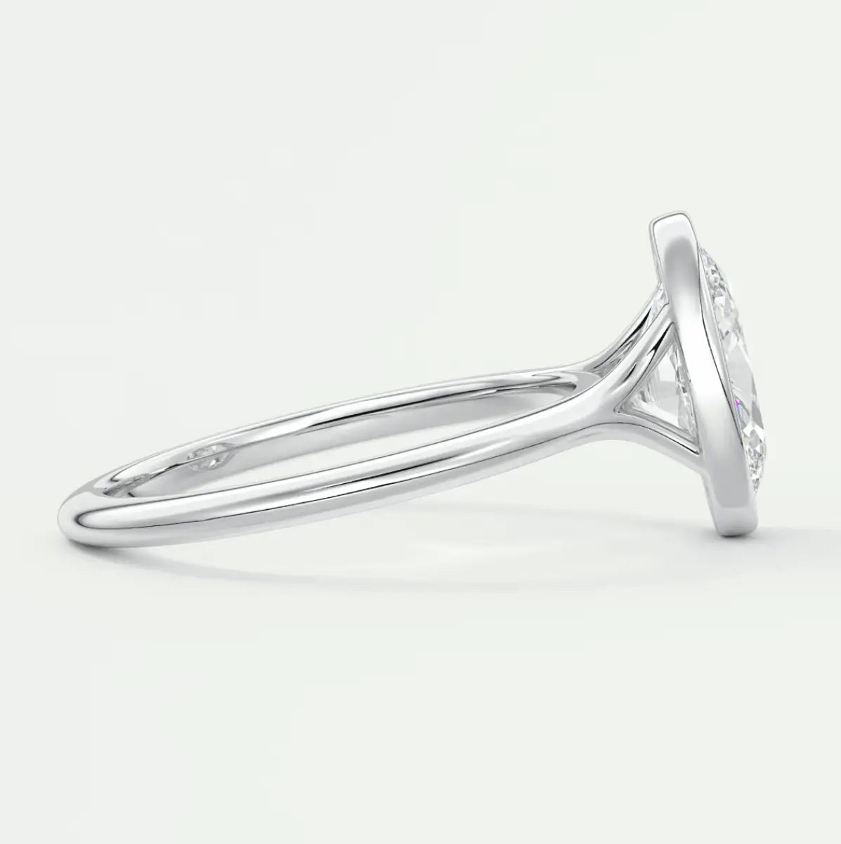 White gold diamond engagement ring with a round cut center stone and band adorned with small diamonds.