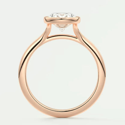 18k rose gold engagement ring with a round diamond center stone.
