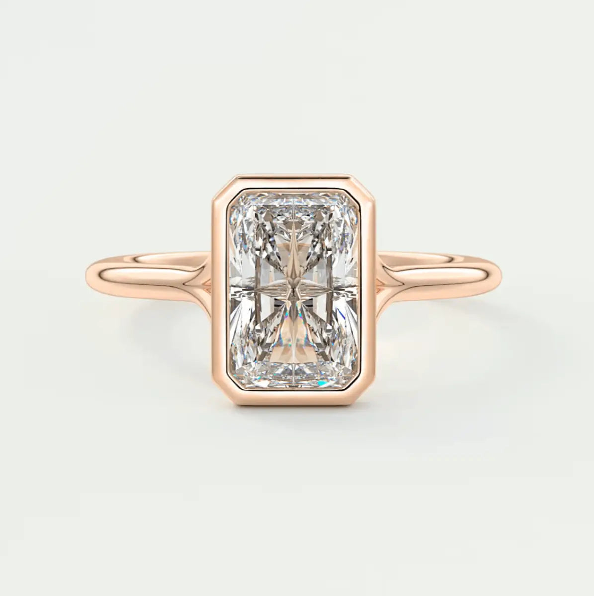 18k rose gold engagement ring with a radiant cut diamond.