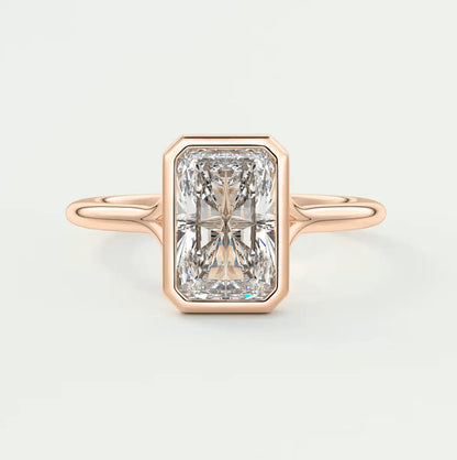 18k rose gold engagement ring with a radiant cut diamond.