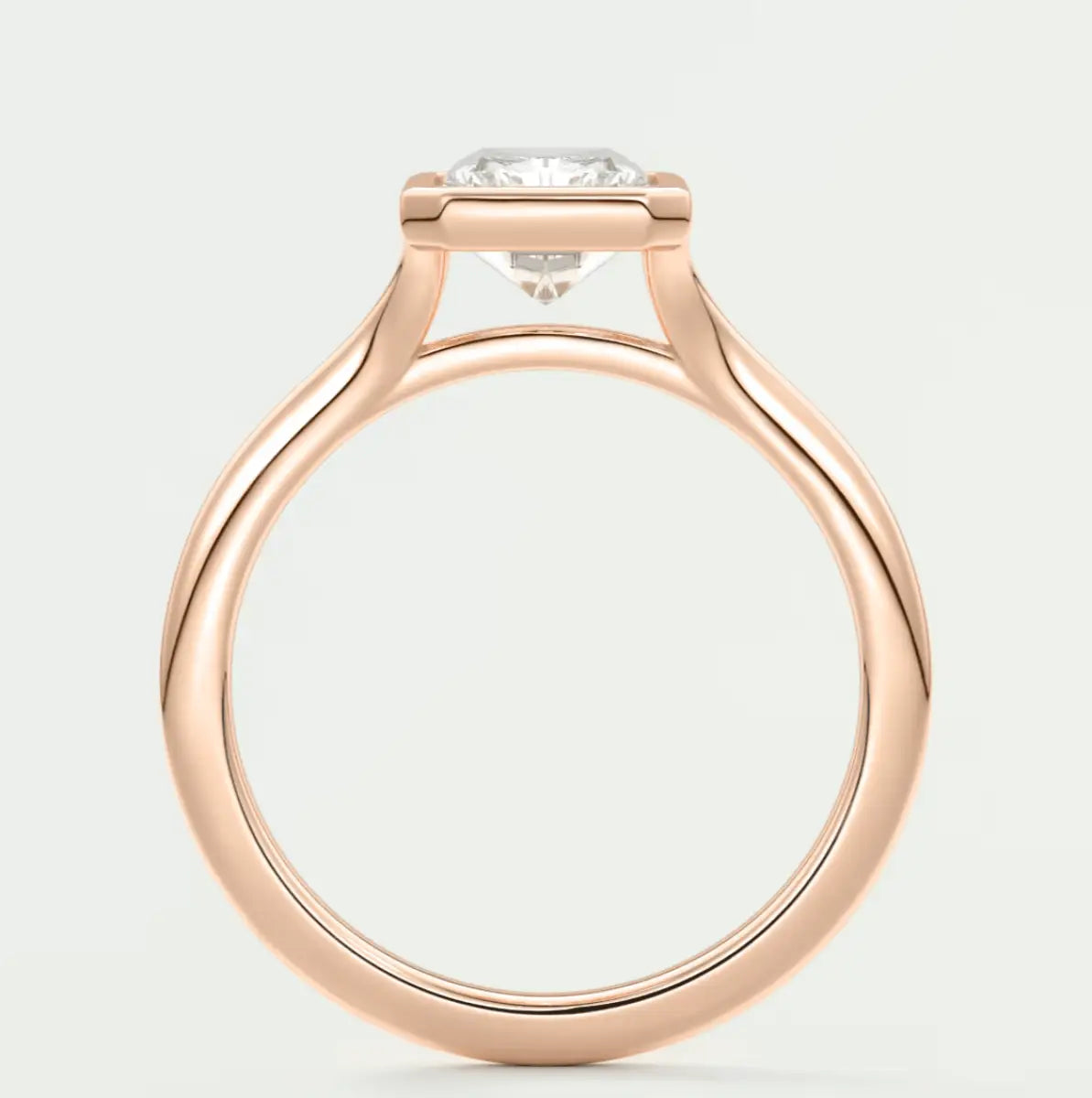 18-karat rose gold engagement ring with a round diamond.