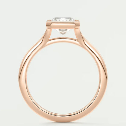 18-karat rose gold engagement ring with a round diamond.