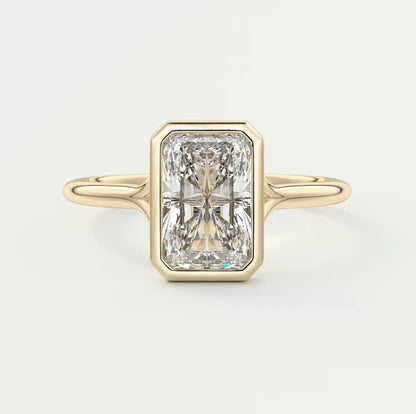18k yellow gold engagement ring with a radiant cut diamond.
